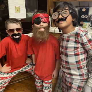 Three boys having a great time with the disguise kit.