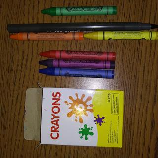 The box of crayons compared to a standard Bic pen.