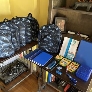 6 shark theme backpacks all filled with the same school supplies