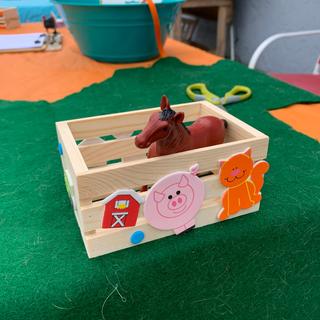 plastic horse in wood crate