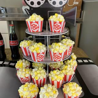 Movie reel cupcake stand with "popcorn" cupcakes
