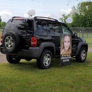 Yard sign in front of a jeep liberty
