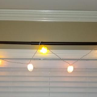 Egg light strand on window curtain rod