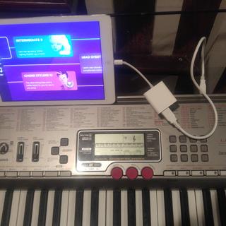 See the cord in the photo which connects my piano to my iPad for the Simply Piano learning app.