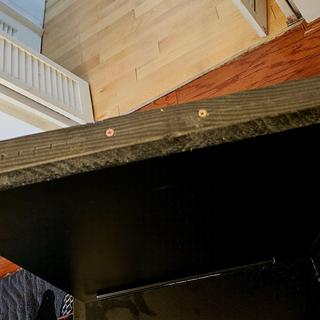 Raise the desk with ripped 2x4 and cabinet screws.