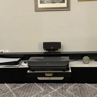 Speaker behind the retracted floor-rising screen situated on the 18" stand.