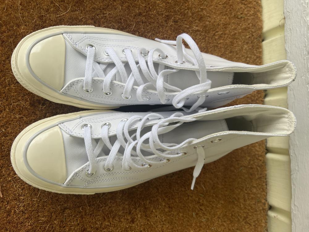I love these Converse. I have several pair and these are on the top of my favorites. The leather is buttery soft and not stiff at all. They required no break in time and are perfect to wear with a dress or jeans.  The leather is bright white which I love. They are super versatile and comfortable. Both pluses in my book. I sized down half a size as they suggested and they fit just perfectly. The gray line on the rubber part adds some dimension too which is nice. The only reason I took off one star is for the color of the sole & rubber. The leather is bright white and the rubber parts lean a tinge yellow, I had wished for them to be bright white as well. However, this won’t stop me from wearing them though. If you are wanted an elevated style Converse I recommend these.
