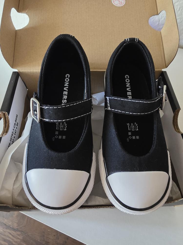 I recently got the Chuck Taylor All Star Dainty Mary Jane Toddler Low Top Shoe in black, & I’m very happy with them!

Fit & Feel: True to size with a secure yet comfy fit. The Mary Jane strap adds stability, perfect for active toddlers. The flexible sole makes them great for all-day wear.

Design: A cute twist on the classic Converse! Sporty yet stylish, they pair well with any outfit. The low-top design makes them easy to slip on, a huge plus for wiggly little feet.

Fabric: The lightweight, breathable canvas keeps feet cool & is easy to clean, though the white soles do attract dirt.

What I Loved Most: Versatile, stylish, & they stay on well!

What I Would Change: The white sole shows dirt fast—an alternative color or stain-resistant material would be great.

Overall, these are stylish, comfy, and functional toddler shoes. I’d definitely choose them again!