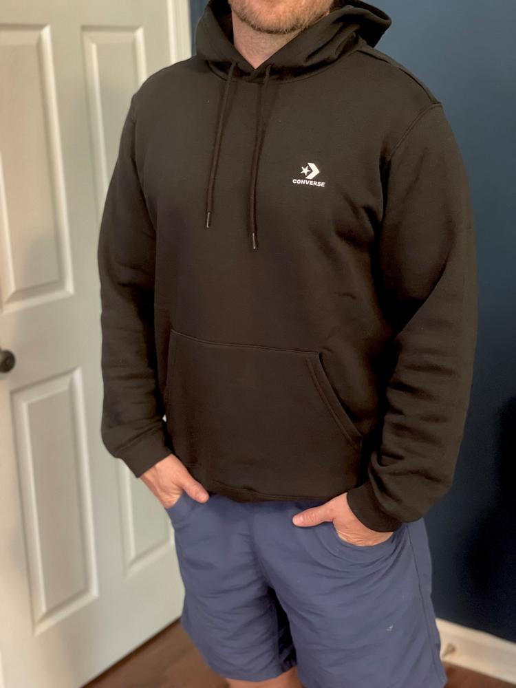 The overall fit is a true to size large. I'm around 210 and 6'1 and it fit great. Material is comfortable and has a nice stretch to it, for a good give. Logo isn't obtrusive. I think this hoodie makes for a great simple black hoodie for everyday casual wear. Have no complaints on the hoodie after wearing a few times and washing. Material stays comfortable and soft post wash as well.