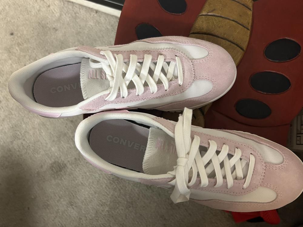 This stylish shoe exceeded my expectation. It’s truly a lifestyle shoe that gives a casual athletic look. Fit is comfortable and true to size. I typically wear 7.5 Nikes and this felt similar. I love the two-tone white and pink with the perfect balance design. It’s not overwhelmingly pink. Fabric CAN absorb and hold onto dirt and colors more easily but I still prefer the fabric look over the smooth/leathery material. The only issue I have is the bottom half of the shoe (sole) is rather a thick and heavy layer so much that when I walk I felt like I was making a lot of noise as the shoe fell heavier on the ground.