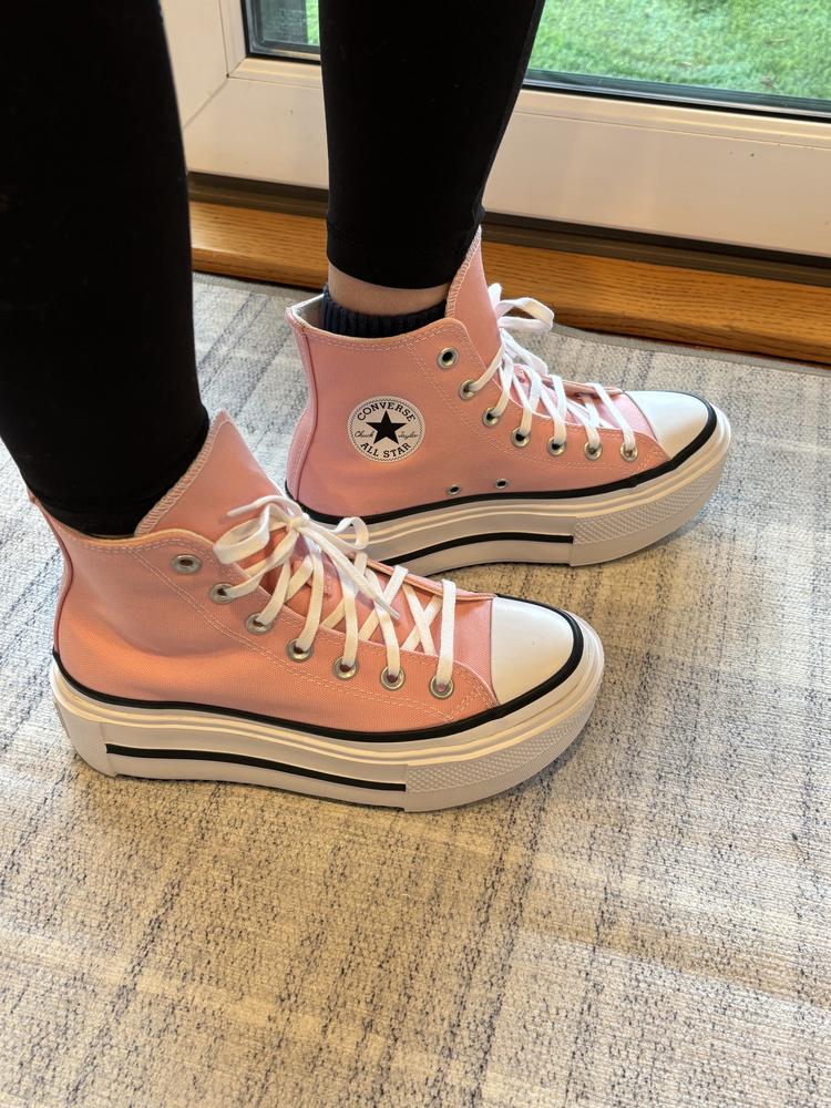 Oh my gosh, these are amazing sneakers that are so comfortable, cute, and even give a me couple of extra inches in height. They could quite possibly be the perfect sneaker. In my opinion, they fit true to size and feel so comfortable while wearing. The sole has plenty of cushion and even with the stacked sole, the sneakers are still really light, making it so easy to wear them all day. The design is timeless, like all Converse, and the pink color is the perfect shade of light pink. The canvas fabric is sturdy and I feel like they will last a long time, but not so stiff that the high tops are uncomfortable. I love that these are an updated feel to the classic Chuck Taylor and that you can get some extra height without sacrificing comfort. There's also a decent tread on them, making them more versatile than traditional Chuck Taylors. All around, a phenomenal sneaker to add to your collection.