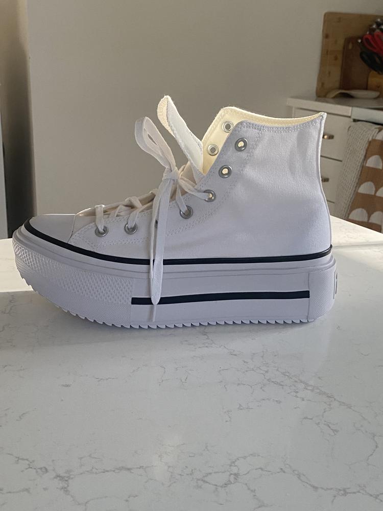 I love these Converse platform high tops so much! The classic white color with the bold black stripe detail makes them super versatile. I’ve paired them with shorts, skirts, and jeans, and they always look very stylish and cool. The platform adds just the right amount of height without feeling heavy or bulky, and it gives the shoe a fun, trendy vibe compared to the original Converse style (which I also love).

The canvas material feels durable and high quality, just like you’d expect from Converse. These fit true to size for me, and they’re surprisingly comfortable right out of the box. They’ve definitely become my new go-to sneaker. I can’t wait to keep styling them with different outfits!