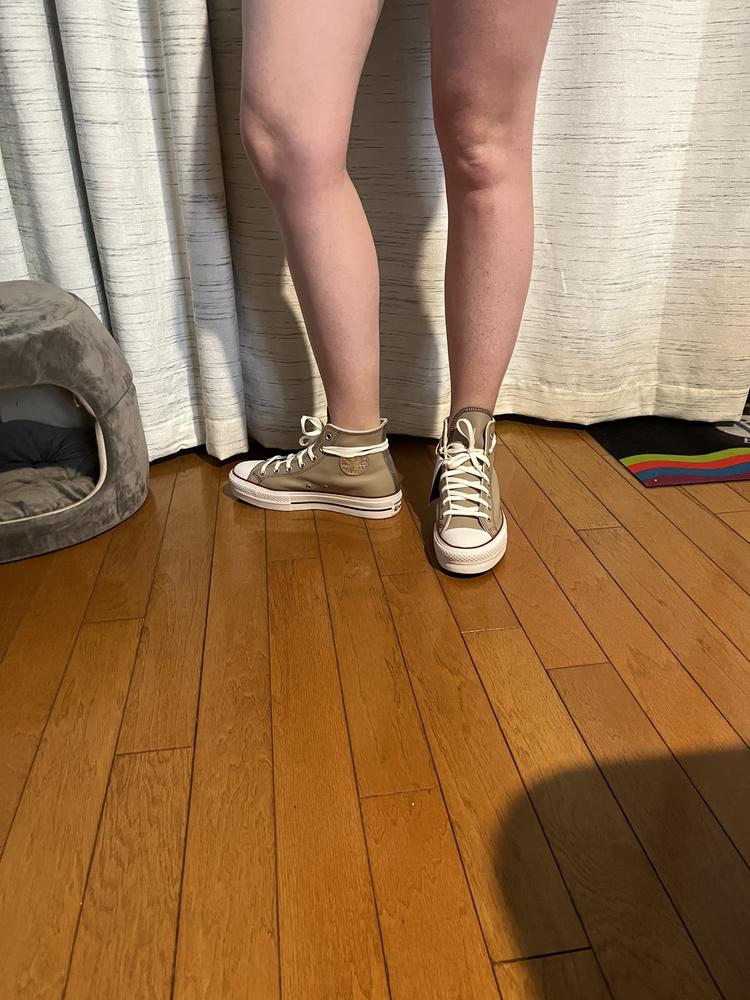 I had so much fun customizing my Chuck Taylor Platform high top boots. First of all, I love the beige leather and the silver leather strip and Converse star. These shoes look really expensive yet trendy, but also remind me of the Chuck Taylors I owned and loved as an adolescent. I thought the warm lining inside was a nice touch and extra cozy - definitely worth it if you’re looking for extra cozy toesies. I also thought the shoelace feature where it tied around the back was neat. I have never had shoelaces wrapped like that before, but it made me feel more youthful and on tend. The shoes fit true to size. For reference, I am 5’10” and I was worried the platforms would make me mega tall, but I was pleased that it was a small platform and they looked great on me. I don’t know what I would change except maybe offering elastic shoelaces that don’t require tying or different shoelace colors - although, not a deal breaker. Overall, I give these a 9/10 for comfort and style. Great job!