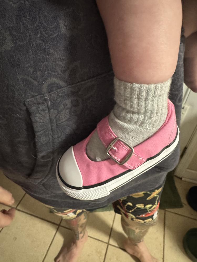 Cute slip on for my little one. She’s not able to walk yet but I love how easy they are to slip on and off with the Velcro strap. They also do a great job of staying on and my child has very active legs. Quality is what you would expect on any pair of chucks and should last much longer than she will be able to fit in. You can dress them up or down just as easily. The only downside I could imagine is a lack of support from such a flat shoe. Overall I’m very pleased with these shoes!