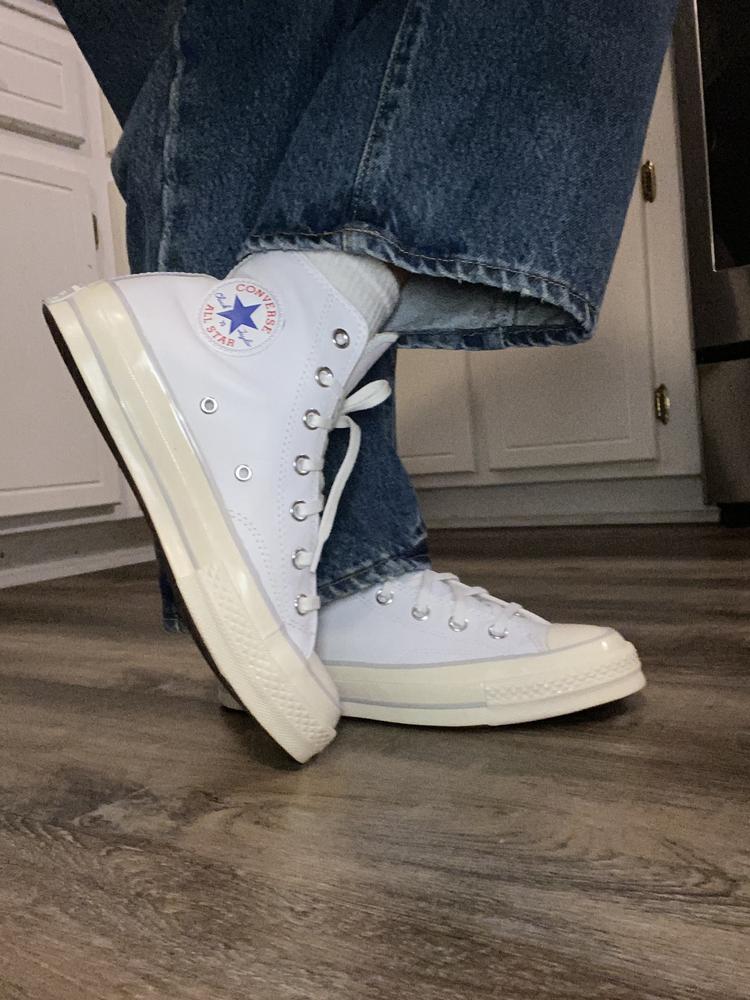 I love these leather Converse Chuck 70’s. The two tone white is nicely done and very on trend right now. They fit true to size and are very comfortable. I was worried the leather might make them stiff feeling but after wearing a full day they are just as comfortable as my other Converse. I received several compliments on them and people were impressed with the design and material. I love the look and design. The white is very crisp and clean looking. The leather is soft and feels like good quality leather that should last. The only thing I would change was the shoelaces need to be a little longer. The laces were too short to lace all the way up and tie.