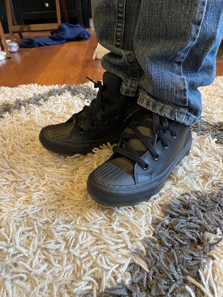 Here in Minnesota, we are in that season of late fall where many days are a bit too chilly or damp for sneakers, but full on boots are overkill. The Converse Chuck Taylor All Star Berkshire Boot is  the perfect hybrid type shoe that my little buddy can throw on in the morning, wear all day, and not have to worry about soggy feet if he finds a puddle or two during the school day. 

With a substantial sole and wrap-around rubber, his toes will stay dry. With a sleek, stylish profile, he will not need to bring a spare pair of shoes to change into when indoors. 

Out of the box the fit was a little narrow, but by loosening the laces a bit we were able to zero in a comfy fit for his growing feet.