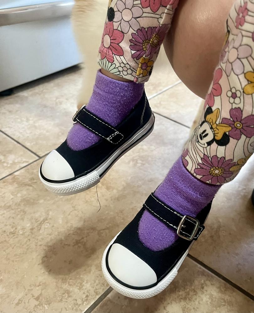 These shoes are super cute! The strap keeps them secure, and they’re easy to put on and take off, which is a huge plus. The fit is great, and they’re lightweight and comfy to run around in. They go with everything and look adorable—love them!