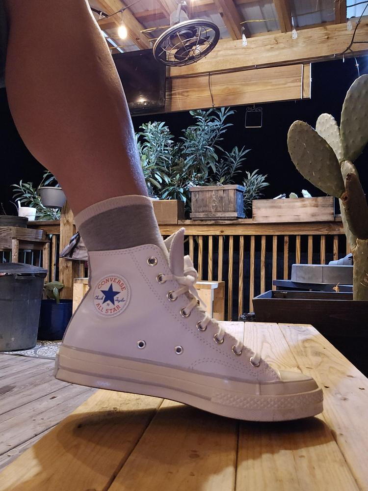 I am fan-girling over these Converse Chuck 70's!! I could go on about the white leather for days, it is genuinely beautiful. The Egret soles make the white leather look bright and bring a cool dynamic style together. They are really high-quality sneakers, that were designed to perfection. They feel and look really well made and the retro look eats!! I could style these shoes for days. I already have so many ideas and outfits I am planning to rock with these Chuck 70's! I think my favorite outfit so far has been these shoes and my favorite bell bottoms to get the full '70s feel. The shoes are extraordinarily comfortable, and the design is ingenious. I am pretty clumsy so the rubber toe cap comes in handy! My chucks are so comfortable I would rather walk in them than barefoot. They are loaded with cushion and padding making them great for long strides or a hard days work. I have high arches in my feet and these shoes fit my feet so perfectly, the OrthoLite cushioning is fabulous.