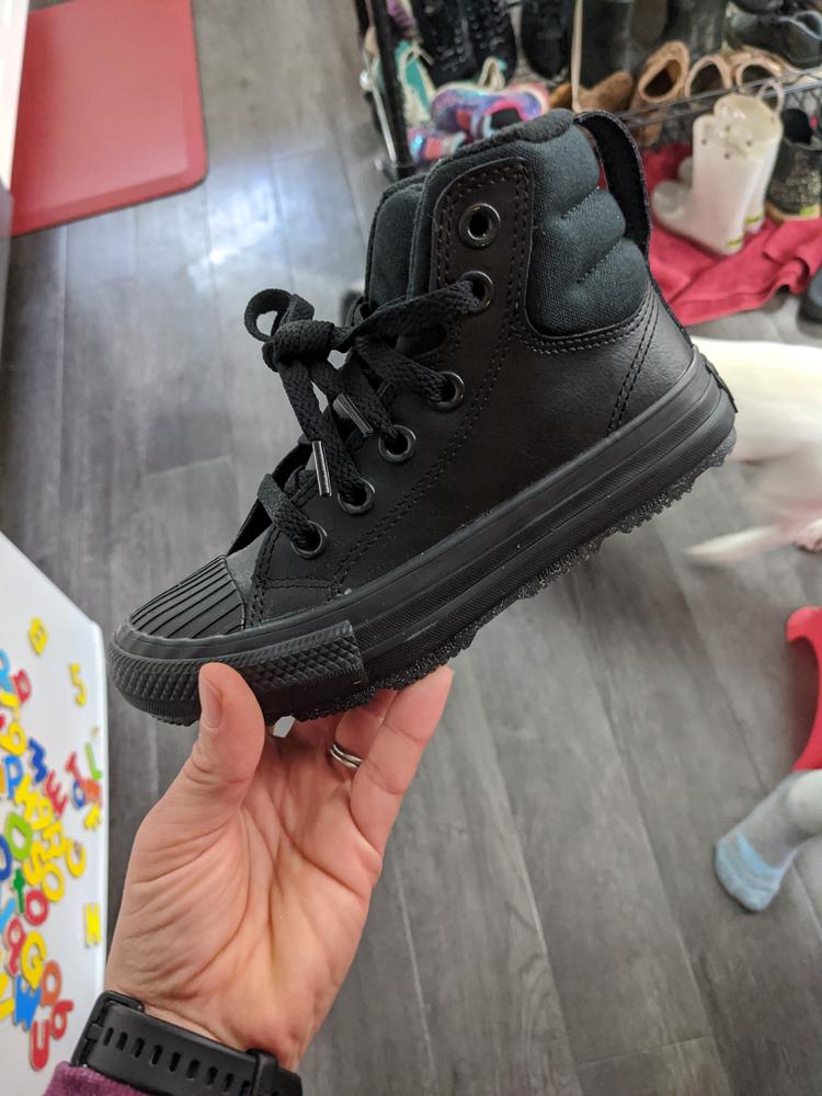Converse is hands down my favorite shoe brand. When I saw this high top boot crossover (not official, but how I see this shoe) I knew I needed to give them a try. My kids are close in age so we got them to fit the oldest now, with the intent of passing them down. (High hopes they will make it to the next kiddo!) They are true to size. After some off trail hiking, where feet stayed warm and dry, and slipping was kept to a minimum. And several days of school day wear, I am happy to report these shoes are an A+. The high top design took my 6 year old a bit to get used to the first time, but they have been successfully wearing them since.  The tred is thick for slippery conditions, and the entire shoe is sturdy and warm. They wipe clean with a damp paper towel and have a minimalist style that makes it wearable everywhere. 
These are an excellent addition to any closet,  especially those living  with cold weather!  I may need to purchase them in my size 😄