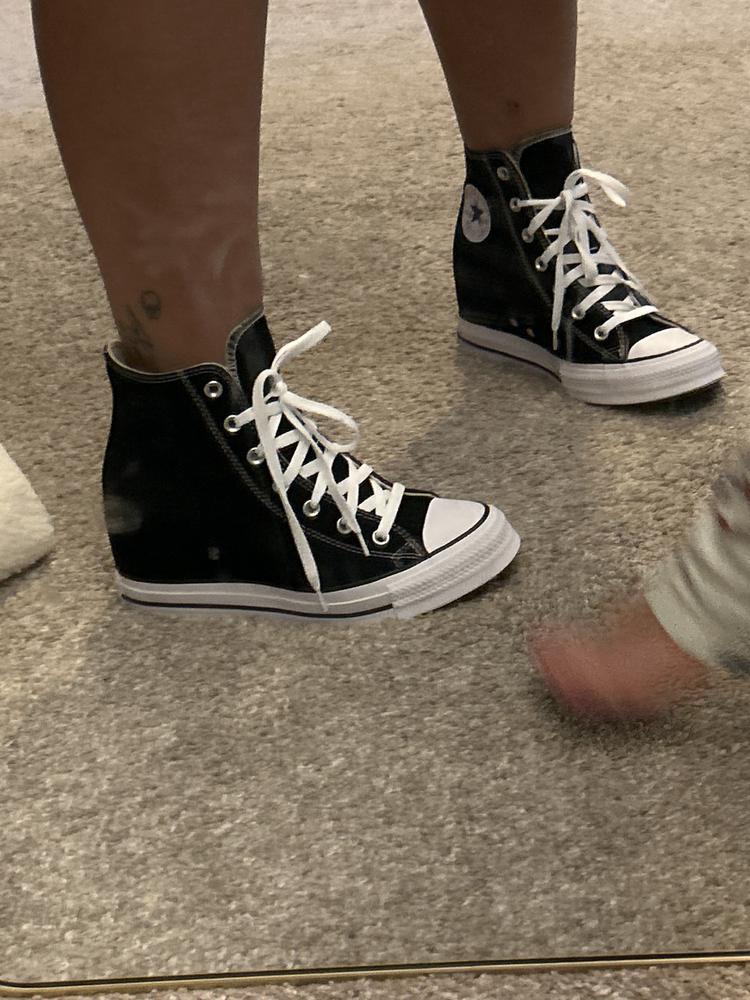 I have owned many pairs of converse over the years and always love them! I have never had the wedges though and I AM A FAN! These are true to size, I usually wear a women’s 9.5-10 and I got the 9.5 and they fit perfectly! I do have a very wide foot so they are always a little tight on me, but that is completely my anatomy. Nothing with the shoe. This is a common issue for me so if you have wide feet just know you might want to size up for a little more space. I love the design of the shoe because it’s a wedge without being able to tell. It’s a wedge it makes your legs look great while you almost look like you’re just wearing a pair of high tops. It’s a very cute design to wear with a casual dress or even shorts or a pair of jeans to add a little height. The fabric is the same as classic converse and I always love the fabric, it holds up well and even as they age the distressed look is still so cute. I will be wearing these a lot all year round!