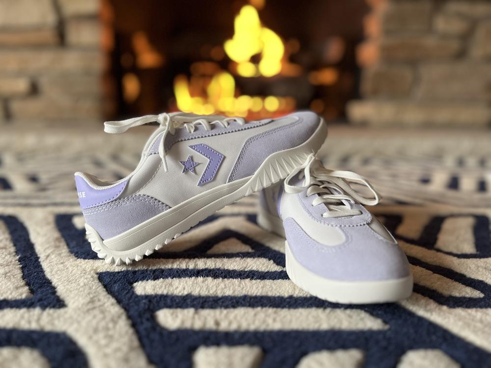 The Converse Run Star Trainer takes everything great about classic Converse and adds a subtle, sporty upgrade. They’ve got the same effortlessly cool vibe but with a touch more support and a streamlined, modern feel. I love the feminine lavender color; it’s almost a neutral so I can wear it with most anything. They are lightweight and easy to wear - no clunky soles or break-in issues; just a solid, everyday sneaker. A quick warning that they do run narrow. I went up a half size and that solved the issue.