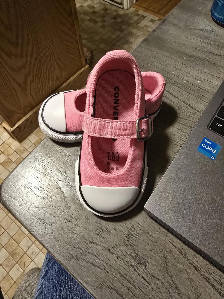 The Chuck Taylor Dainty Mary Janes are the absolute must-have shoe for any little girl! These shoes are not only well-made, but they also have a stylish and adorable design. While they do run a little big, they are incredibly easy to slip onto my daughter's feet. The Mary Janes are the perfect finishing touch to any outfit - whether it's a pair of jeans or a dress, they always look absolutely precious.

These shoes are both sturdy and flexible, making them perfect for active little ones. The bubble gum pink color we chose is just too cute for words! I highly recommend these shoes to any parent in search of a versatile and durable shoe that can be paired with multiple outfits. Trust me, these Mary Janes are the cutest little addition to your child's wardrobe!