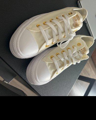 So cute! Goes great with my wedding dress. These are my first Chucks, and with the extra comfort they're very comfortable. My fiance is an everyday All-Star wearer, so it was important to her we wear them for our wedding, and I'm excited to do it. The off-white looked brown when I was customizing, but it's actually ivory that's very close to my dress. The gold looks great! And the blue bottom is cute and jelly-looking.