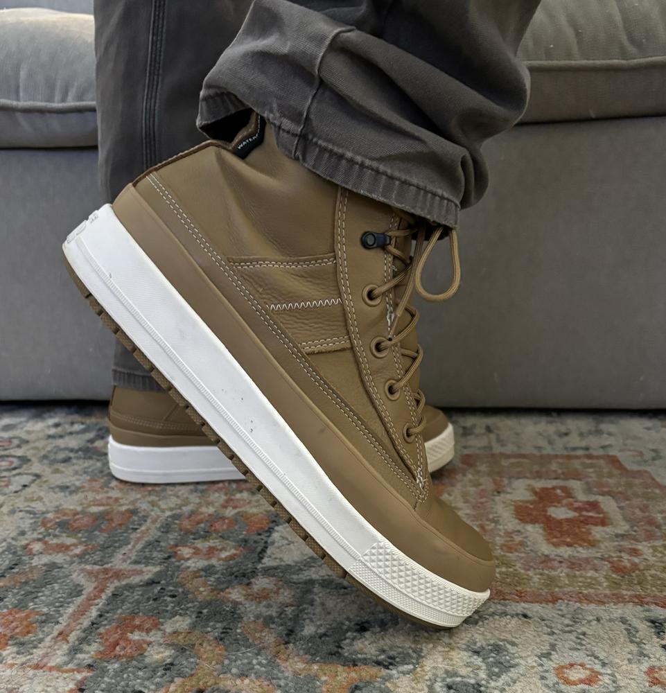 I got these for my husband, I absolutely love the color and simple design. Chuck Taylor’s tend to run a little big. My husband normally wears a size 11.5 and we got him an 11 and they fit great. We got to test out the water resistance during multiple rainstorms and they kept my husbands feet warm and dry! I I love look and feel of this leather, it is soft and has a great satin finish to it, these will be great shoes for the fall or winter but might be too warm to wear year round. Converse always has great quality and these are no exception!