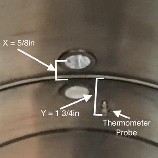 Center of the port is only 5/8” above the bottom and has a temp probe.