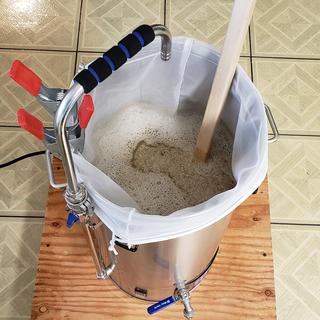 Stirring grains in mash.