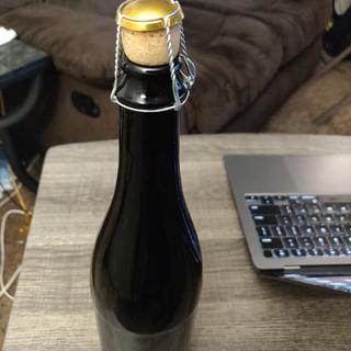 Bottle with cork and wire cage.